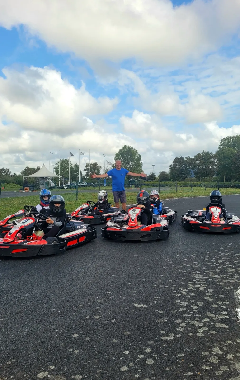 Un moniteur accueille un groupe de karts sur la piste